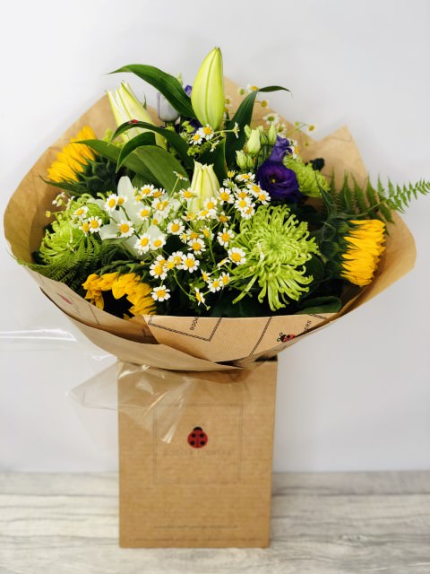 <h2>Sunflower and Daisy Summer Flowers - Hand Delivered</h2>
<br>
<ul>
<li>Approximate Dimensions: 50cm x 30cm</li>
<li>Flowers arranged by hand and gift wrapped in our signature eco-friendly packaging and finished off with a hidden wooden ladybird</li>
<li>To give you the best occasionally we may make substitutes</li>
<li>Our flowers backed by our 7 days freshness guarantee</li>
<li>For delivery area coverage see below</li>
</ul>
<br>
<h2>Flower Delivery Coverage</h2>
<p>Our shop delivers flowers to the following Liverpool postcodes L1 L2 L3 L4 L5 L6 L7 L8 L11 L12 L13 L14 L15 L16 L17 L18 L19 L24 L25 L26 L27 L36 L70 If your order is for an area outside of these we can organise delivery for you through our network of florists. We will ask them to make as close as possible to the image but because of the difference in stock and sundry items, it may not be exact.</p>
<br>
<h2>Hand-tied Bouquet | Flowers in box with water</h2>
<p>These beautiful flowers hand-arranged by our professional florists into a hand-tied bouquet are a delightful choice from our new Summer collection. This bouquet of Sunflowers and Daisies would make the perfect gift to let someone know you are thinking of them.</p>
<br>
<p>Handtied bouquets are lovely display of fresh flowers that have the wow factor. The advantage of having a bouquet made this way is that they are artfully arranged by our florists and tied so that they stay in the display.</p>
<br>
<p>They are then gift wrapped and aqua packed in a water bubble so that at no point are the flowers out of water. This means they look their very best on the day they arrive and continue to delight for days after.</p>
<br>
<p>Being delivered in a transporter box and in water means the recipient does not need to put the flowers in a vase straight away, they can just put them down and enjoy.</p>
<br>
<p>Featuring 1 White Oriental Lily, 2 Tanacetum, 2 Purple Lissianthus, 3 Green Blooms, and 3 Sunflowers, together with mixed seasonal foliage</p>
<br>
<h2>Eco-Friendly Liverpool Florists</h2>
<p>As florists we feel very close earth and want to protect it. Plastic waste is a huge problem in the florist industry so we made the decision to make our packaging eco-friendly.</p>
<p>To achieve this, we worked with our packaging supplier to remove the lamination off our boxes and wrap the tops in an Eco Flowerwrap, which means it easily compostable or can be fully recycled.</p>
<p>Once you've finished enjoying your flowers from us, they will go back into growing more flowers! Only a small amount of plastic is used as a water bubble and this is biodegradable.</p>
<p>Even the sachet of flower food included with your bouquet is compostable.</p>
<p>All our bouquets have small wooden ladybird hidden amongst them, so do not forget to spot the ladybird and post a picture on our social media pages to enter our rolling competition.</p>
<br>
<h2>Flowers Guaranteed for 7 Days</h2>
<p>Our 7-day freshness guarantee should give you confidence that we will only send out good quality flowers.</p>
<p>Leave it in our hands we will create a marvellous bouquet which will not only look good on arrival but will continue to delight as the flowers bloom.</p>
<br>
<h2>Liverpool Flower Delivery</h2>
<p>We are open 7 days a week and offer advanced booking flower delivery, same-day flower delivery, 3-hour flower delivery. Guaranteed AM PM or Evening Flower Delivery and also offer Sunday Flower Delivery.</p>
<p>Our florists deliver in Liverpool and can provide flowers for you in Liverpool, Merseyside. And through our network of florists can organise flower deliveries for you nationwide.</p>
<br>
<h2>The Best Florist in Liverpool, your local Liverpool Flower Shop</h2>
<p>Come to Booker Flowers and Gifts Liverpool for your beautiful flowers and plants. For that bit of extra luxury, we also offer a lovely range of finishing touches, such as wines, champagne, locally crafted Gin and Rum, vases, Scented Candles and Chocolates that can be delivered with your flowers.</p>
<p>To see the full range, see our extras section.</p>
<p>You can trust Booker Flowers and Gifts of delivery the very best for you.</p>
<p><br /><br /></p>
<p><em>5 Star review on Yell.com</em></p>
<br>
<p><em>Thank you Gemma for your fabulous service. The flowers are of the highest quality and delivered with a warm smile. My sister was delighted. Ordering was simple and the communications were top-notch. I will definitely use your services again.</em></p>